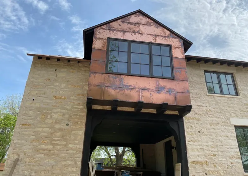 Copper metal panel facade on a stone building for Skylight Installation in Sarasota Springs