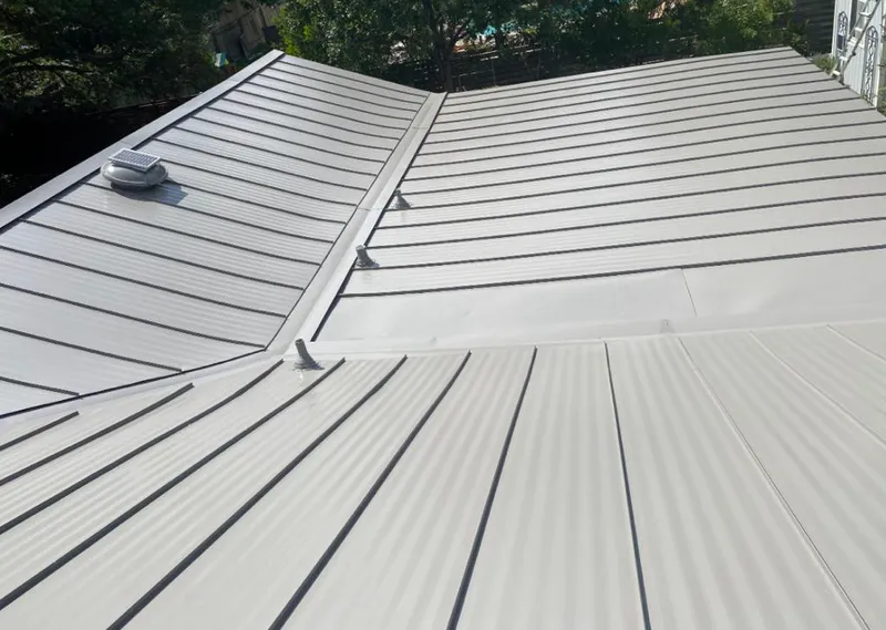 Solar attic fan installed on a metal roof for Roof Ventilation in Sarasota Springs